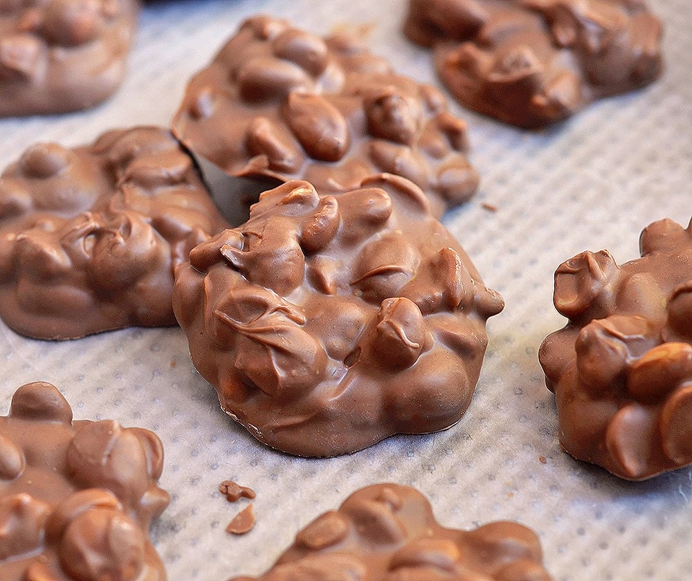 Slow Cooker Chocolate Peanut Clusters on a baking sheet