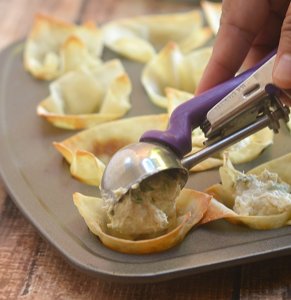 Scoop crab rangoon mxiture into baked wonton cups.