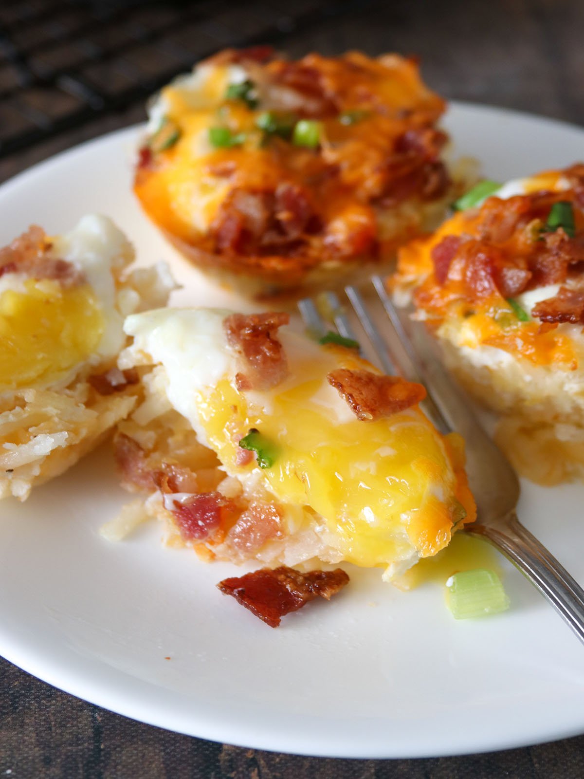 baked hashbrown egg cups with a fork on a plate