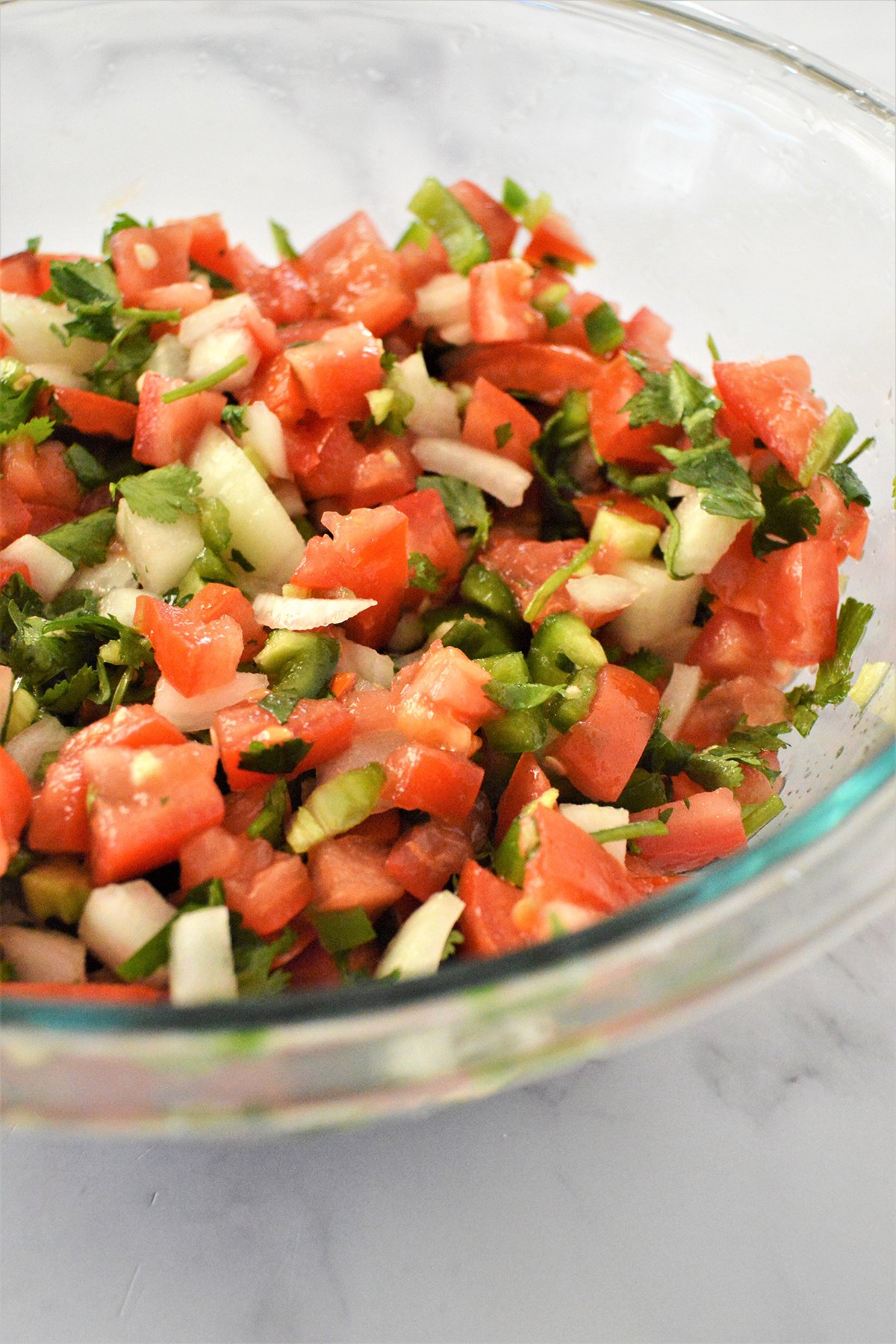 Homemade Pico de Gallo in a clear bowl.