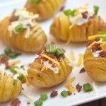 Mini Loaded Hasselback Potatoes turn baby yukon golds into a fun appetizer or side dish! Cut accordion-style, baked and then topped with sour cream, bacon, cheese, and green onions, they're absolutely addicting!