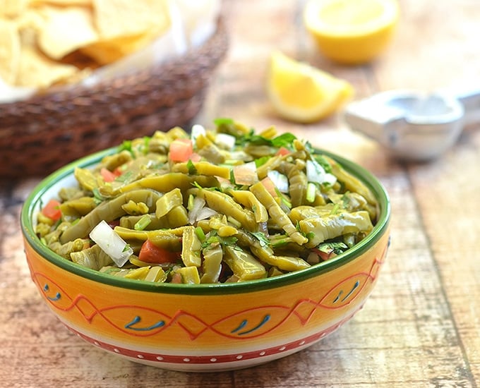 Nopales Salad made with prickly pear cactus, tomatoes, onions, cilantro, chili peppers, and lime juice, is a nutrient-packed salad you'll love. It's fresh, healthy and delicious!