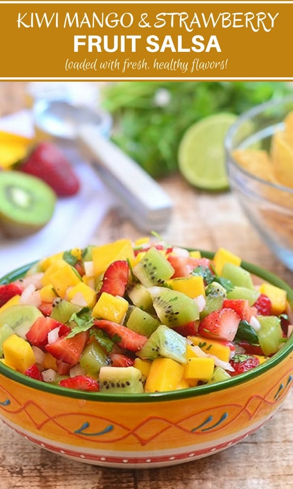 mango salsa with kiwi and strawberries in a serving bowl