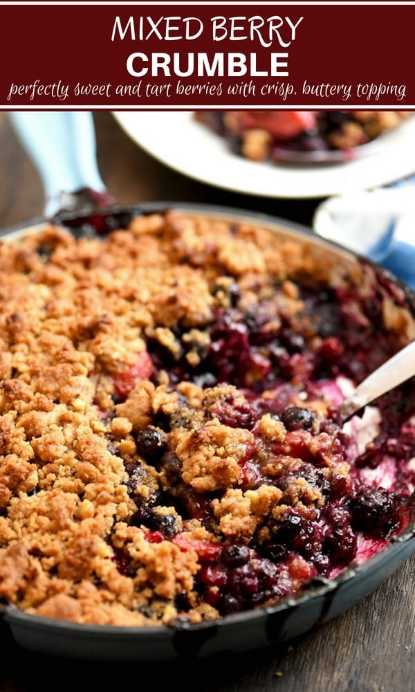 Mixed Berry Crumble in a blue skillet with spoon to serve 