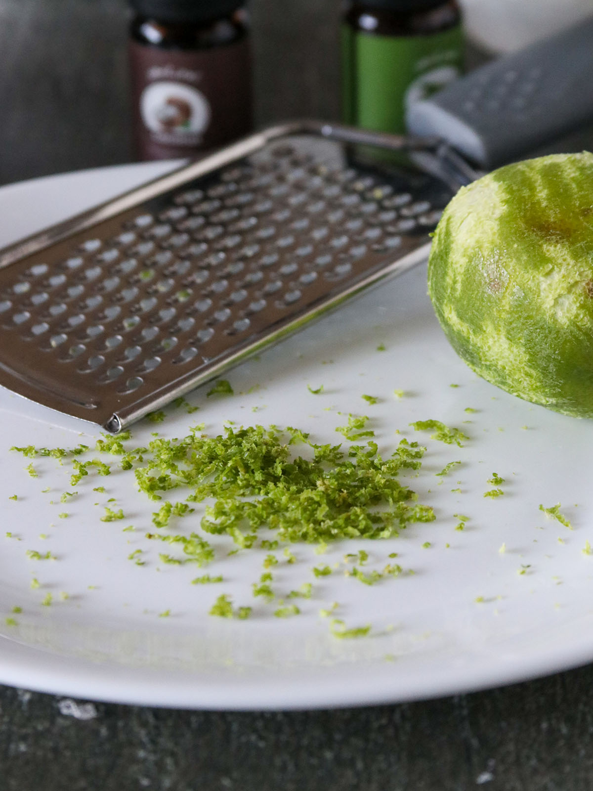 grating lime zest on a plate