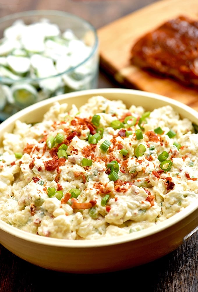 This loaded potato salad is topped with bacon, and green onions for tons of delicious flavor!