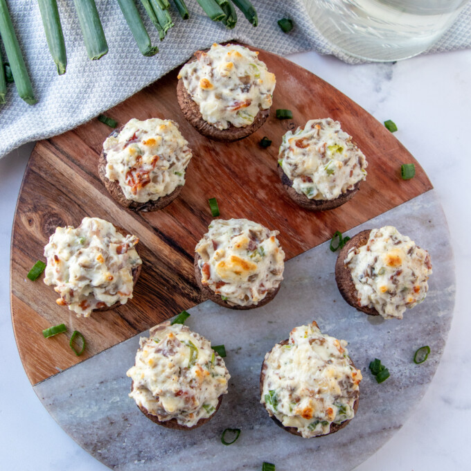 mushroom bites with cream cheese stuffing on a serving board