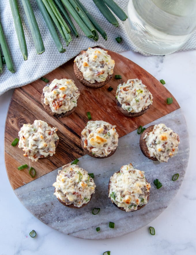 mushroom bites with cream cheese stuffing on a serving board