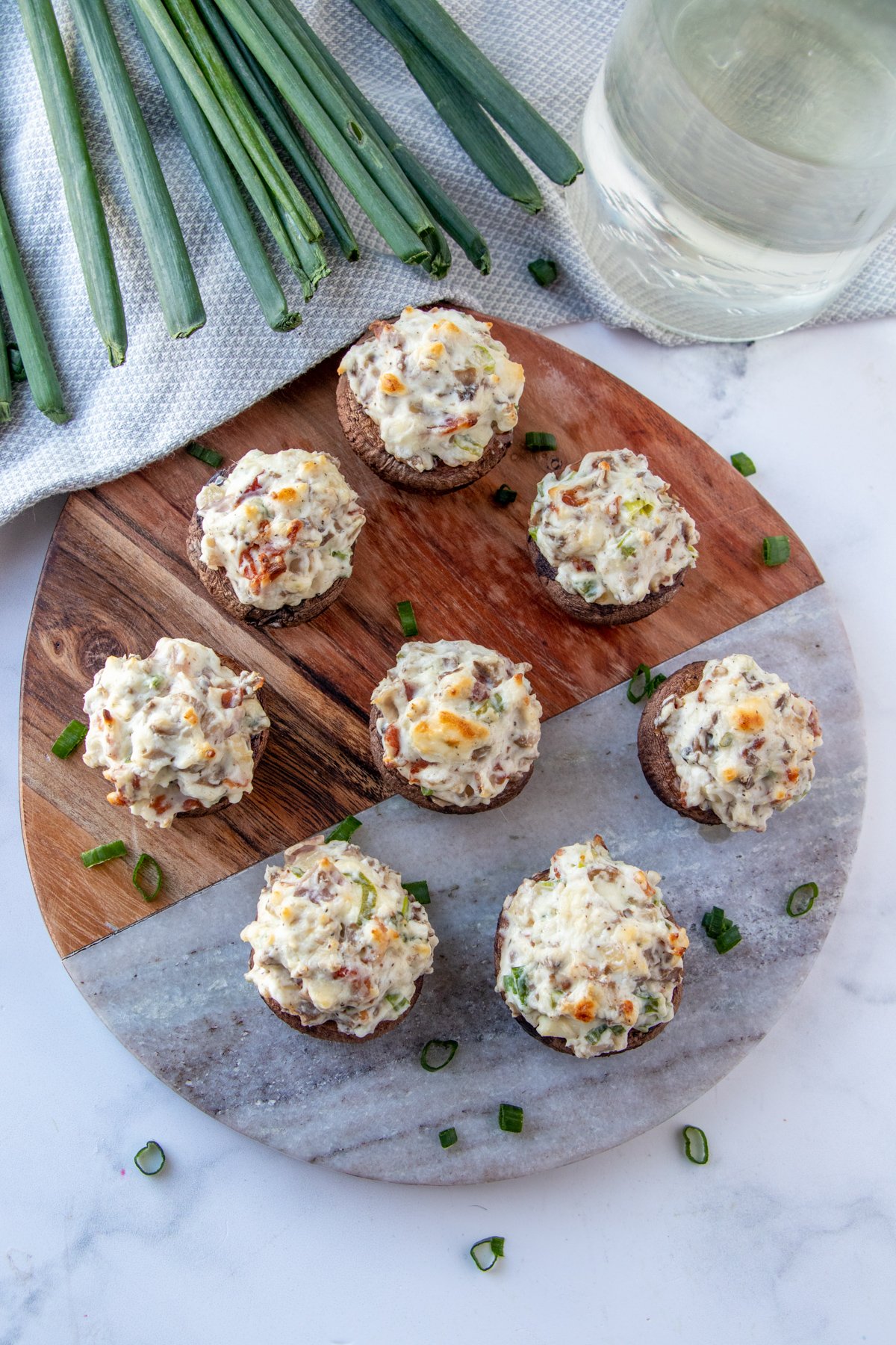 mushroom bites with cream cheese stuffing on a serving board