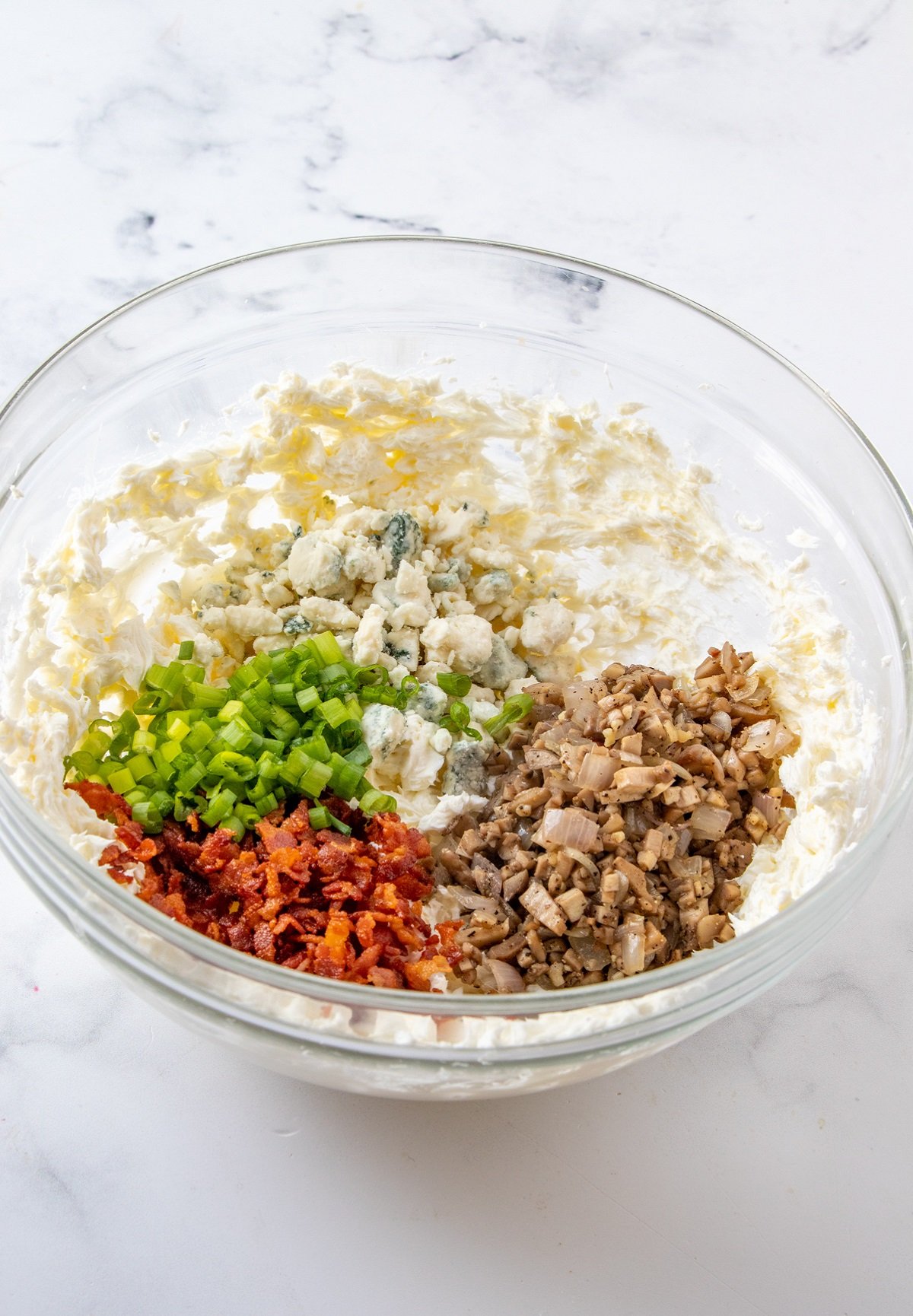 cream cheese, crisp bacon, diced mushrooms, green onions, blue cheese in a bowl