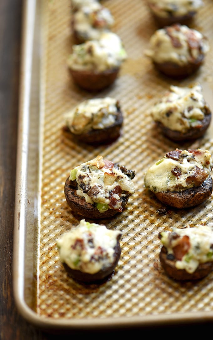 stuffed mushrooms with bacon and cream cheese on a baking sheet