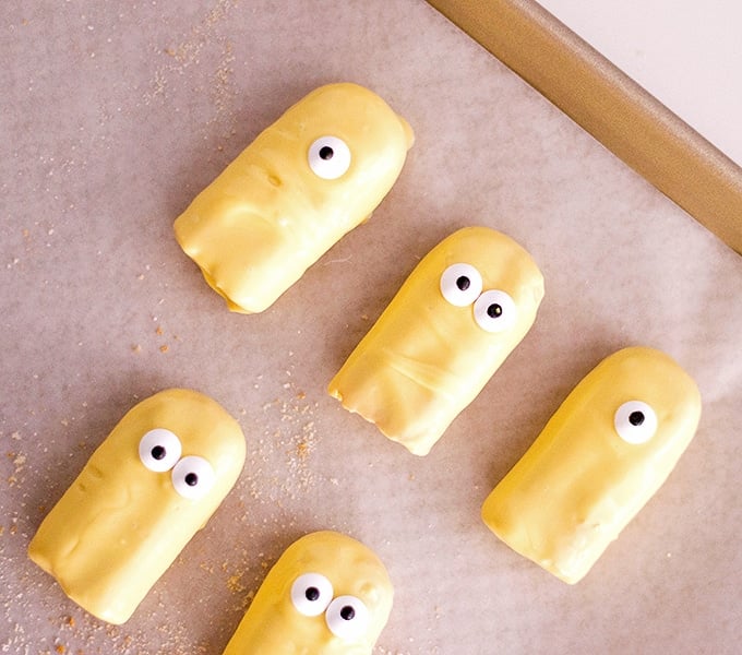 ladyfingers dipped in yellow coating to make Minion Cupcakes