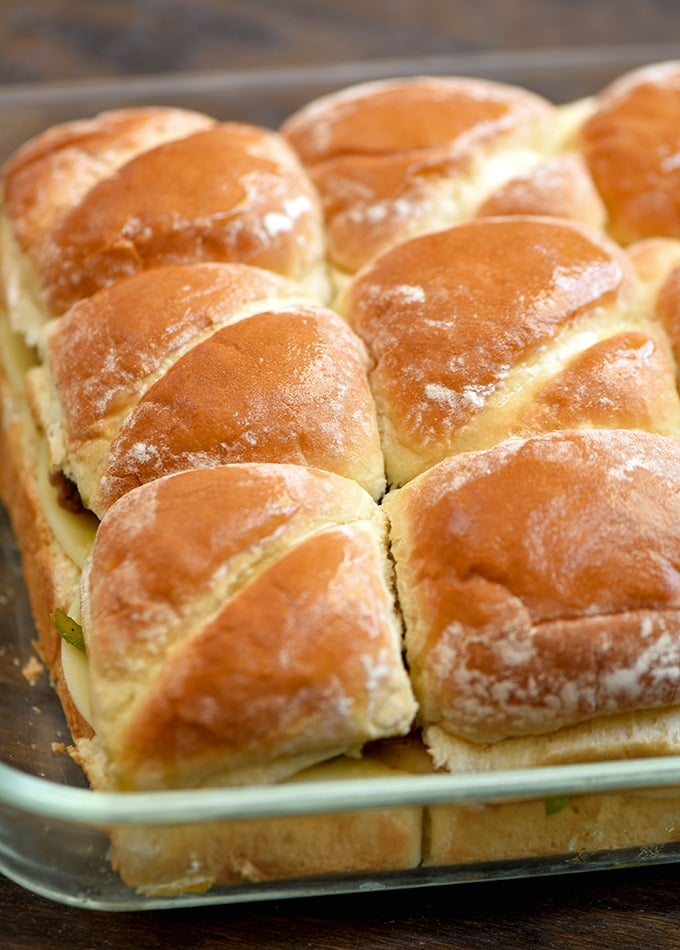 prepared Philly cheesesteak sliders in a casserole dish ready to bake