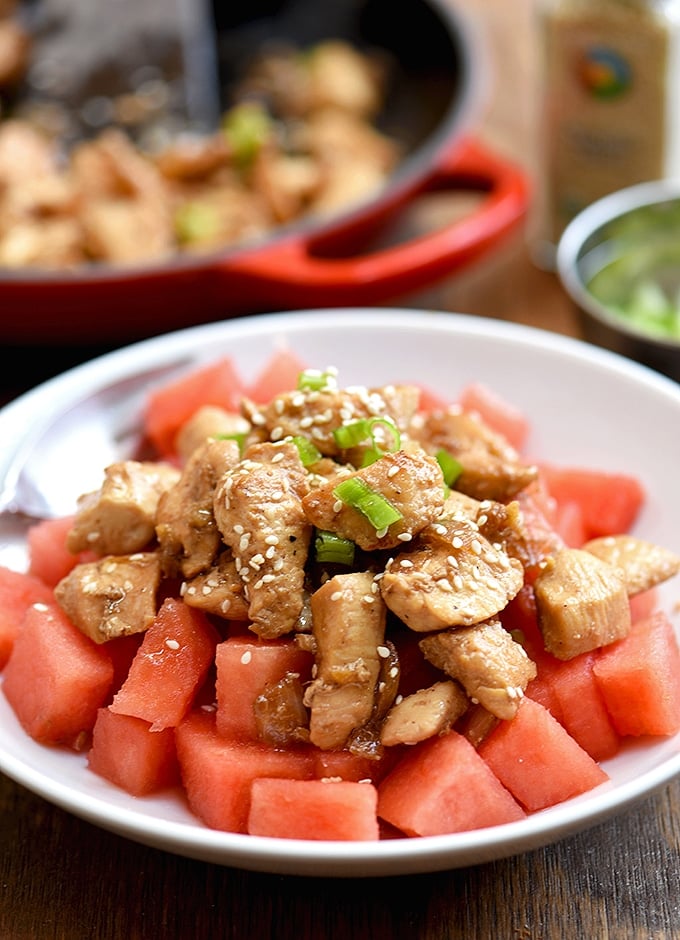 sesame chicken served over cubed watermelon