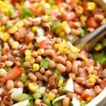 Texas Caviar dip with black-eyed peas, grilled corn, tomatoes, bell peppers, onions, jalapeno, and Italian dressing in a serving bowl