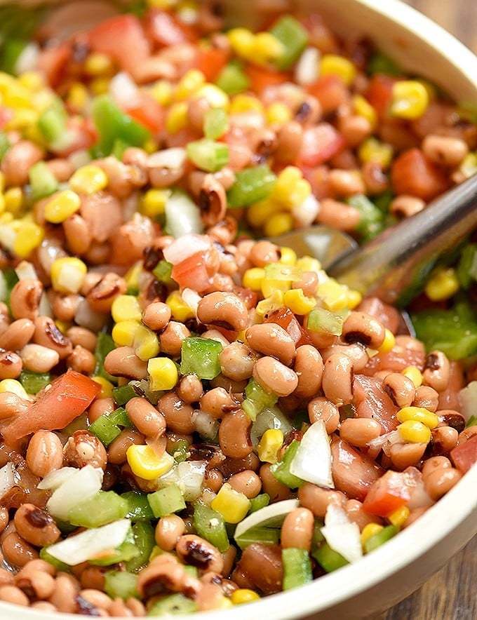 Texas Caviar dip with black-eyed peas, grilled corn, tomatoes, bell peppers, onions, jalapeno, and Italian dressing in a serving bowl