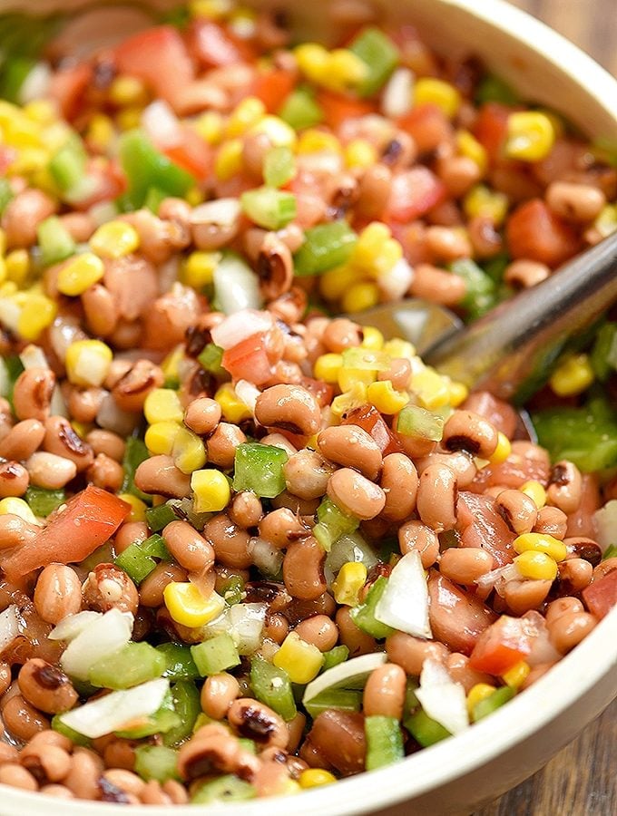 Texas Caviar dip with black-eyed peas, grilled corn, tomatoes, bell peppers, onions, jalapeno, and Italian dressing in a serving bowl