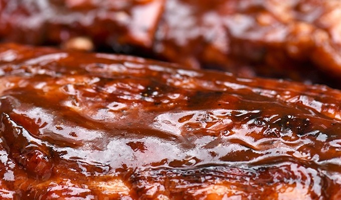 baby back ribs with cola BBQ sauce on the grill