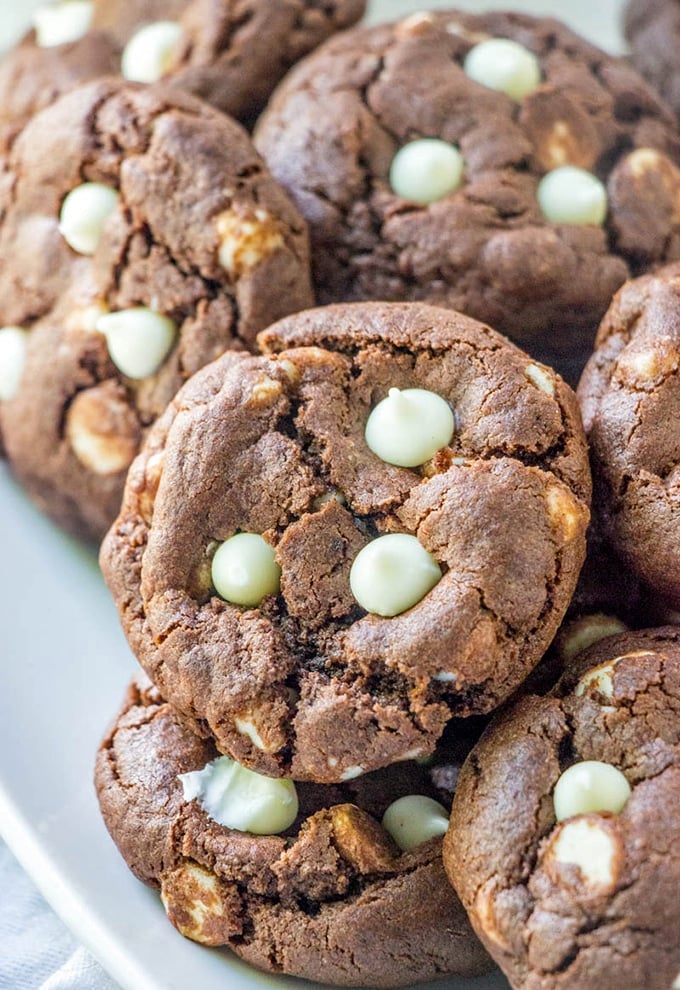 Chocolate White Chocolate Chip Cookies on a plate with a glass of milk on the side