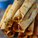 cream cheese chicken taquitos with sides of sour cream and salsa for dipping