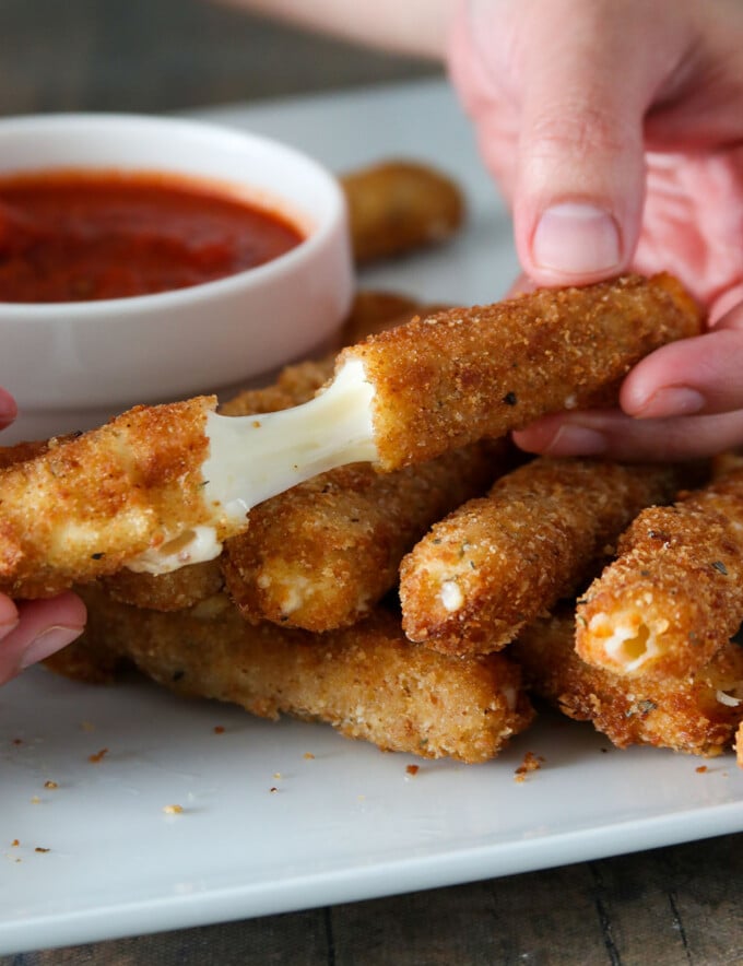 stretching mozzarella cheese with fingers