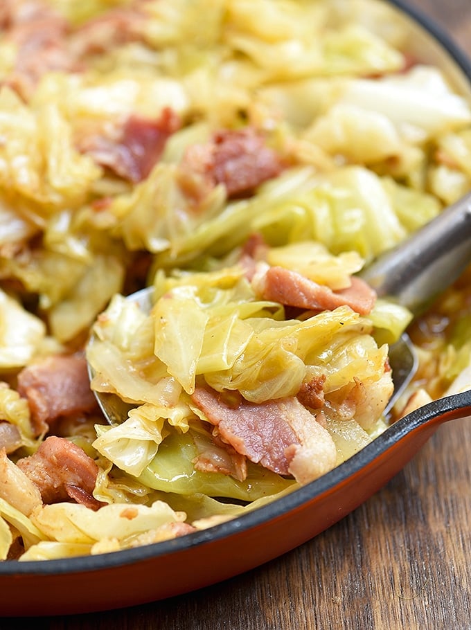 Fried cabbage side dish with bacon in a skillet