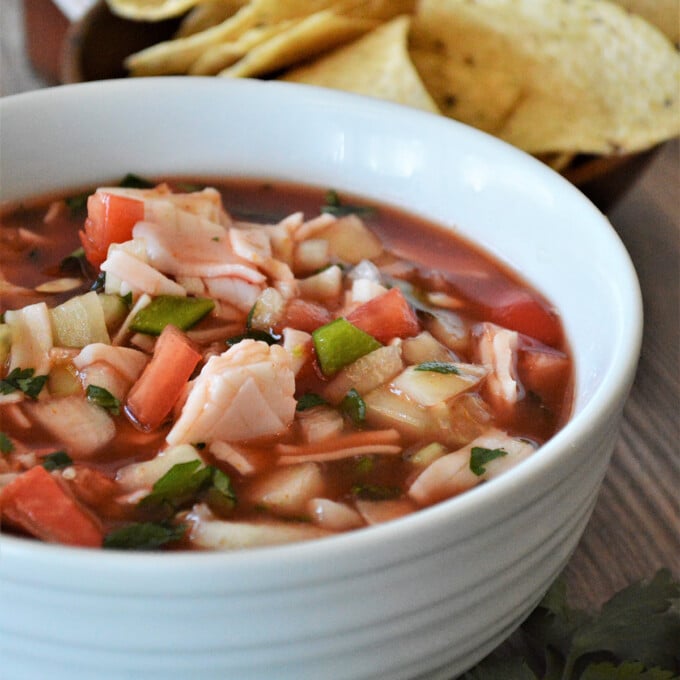 Mexican Crab Cocktail in a white bowl with corn chips on the side