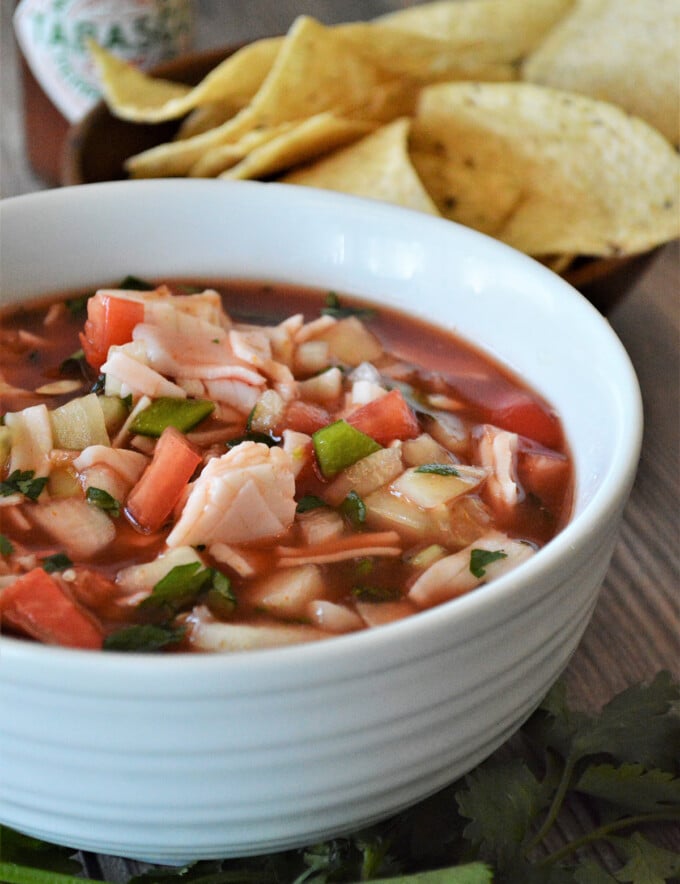 Mexican Crab Cocktail in a white bowl with corn chips on the side