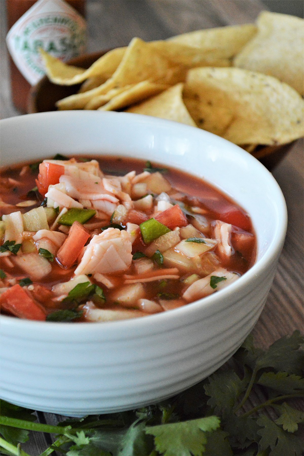 Mexican Crab Cocktail in a white bowl with corn chips on the side