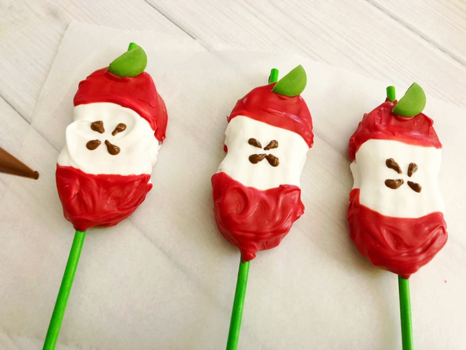 Apple Core Back-to-School Cookie Pops coated with red and white candy melts.