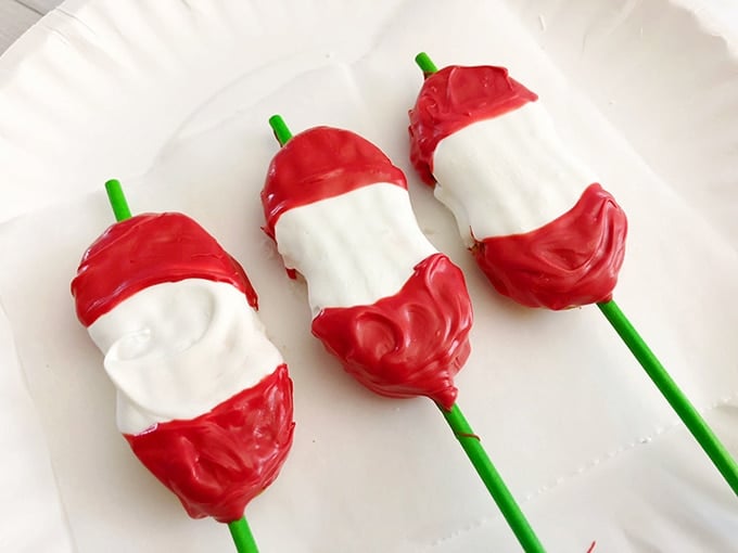 Back-to-school Apple Core Cookie Pops coated with red and white candy melts.