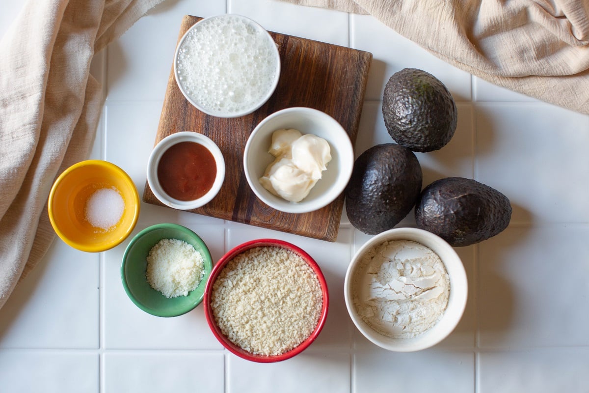 avocados, flour, egg whites, panko breadcrumbs. mayonnaise, bbq sauce, salt, Parmesan cheese in bowls