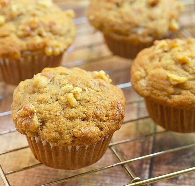 Banana Nut Muffins with walnuts on a wire rack