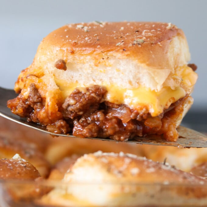 serving baked sloppy joe slider with a spatula