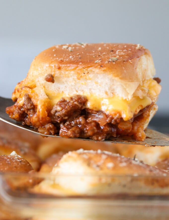 serving baked sloppy joe slider with a spatula