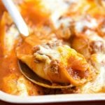 Stuffed Pasta Shells with Meat Sauce and cheese baked in casserole dish