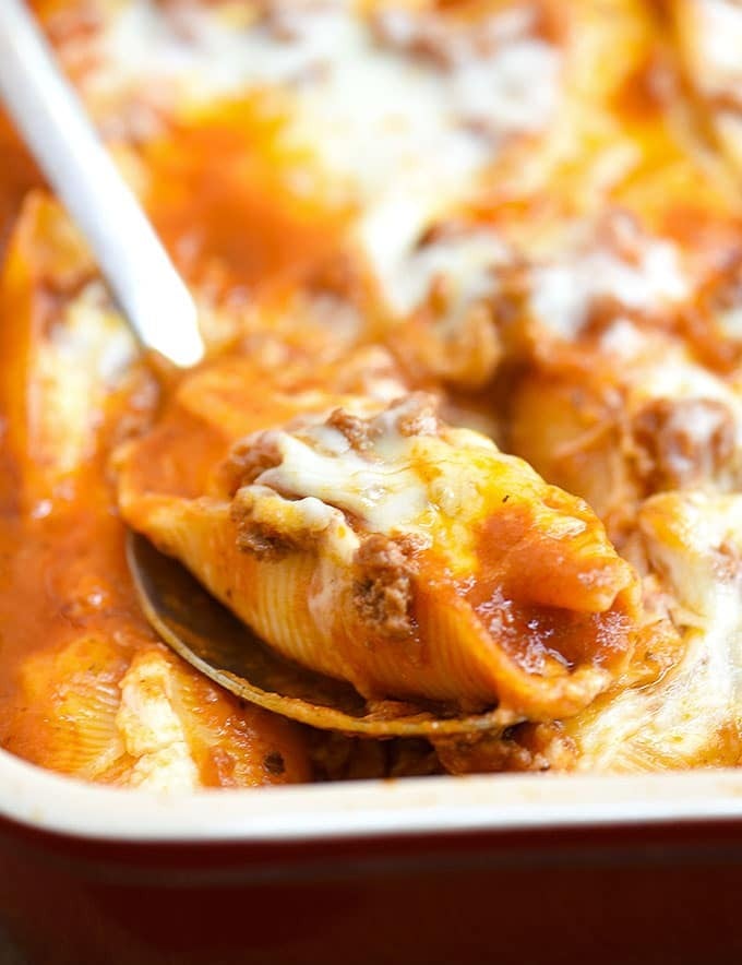 Stuffed Pasta Shells with Meat Sauce and cheese baked in casserole dish