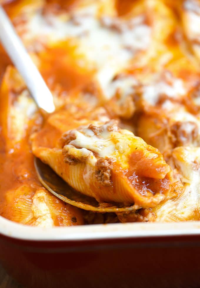 Stuffed Pasta Shells with Meat Sauce and cheese baked in casserole dish