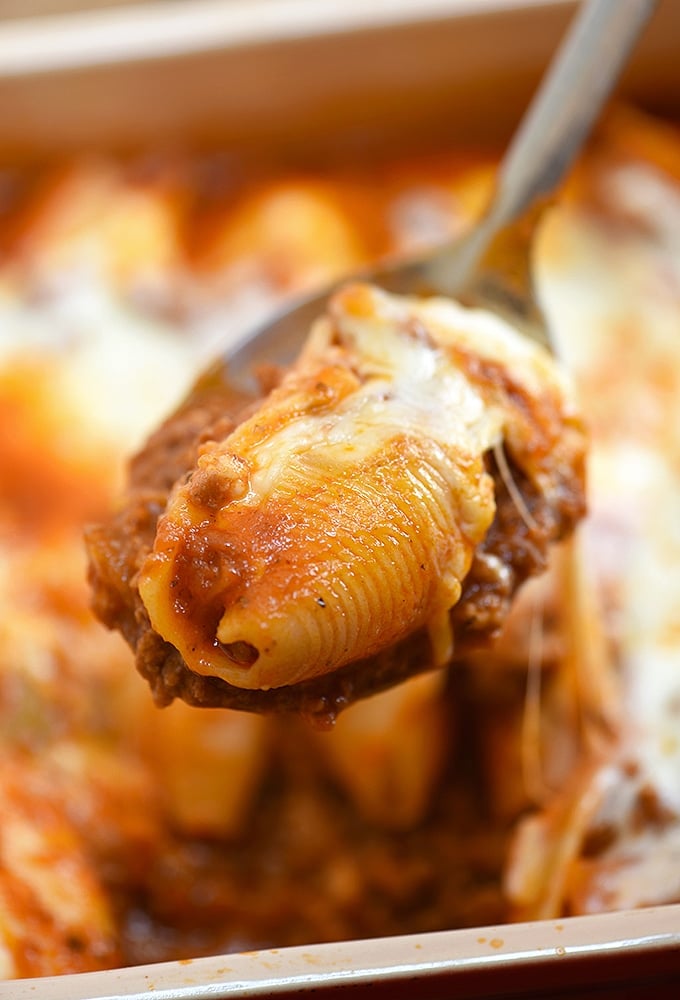 cheese stuffed jumbo pasta shells with meat shells on a serving spoon