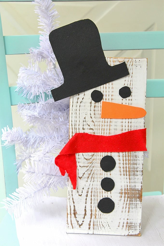 This easy DIY wooden snowman made with an upcycled wooden board is an adorable christmas craft