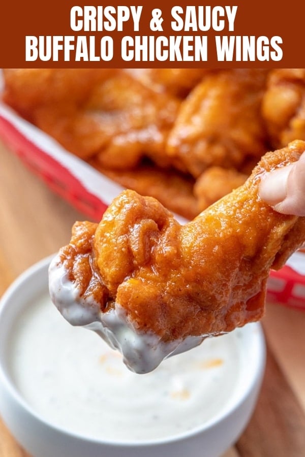 buffalo chicken wings dipped in a bowl of ranch dressing
