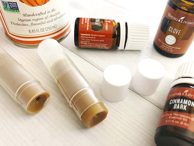 pumpkin-flavored homemade chapsticks and bottles of essential oils - an easy DIY gift for the Holidays