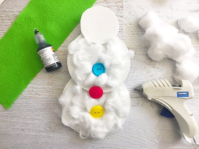 blue, pink, and yellow buttons glued on cotton ball snowman craft