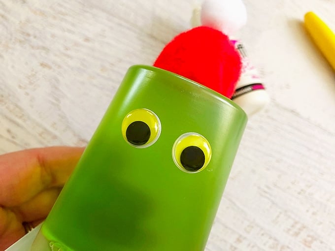 glue googly eyes on green jello cups to make Grinch snack cups