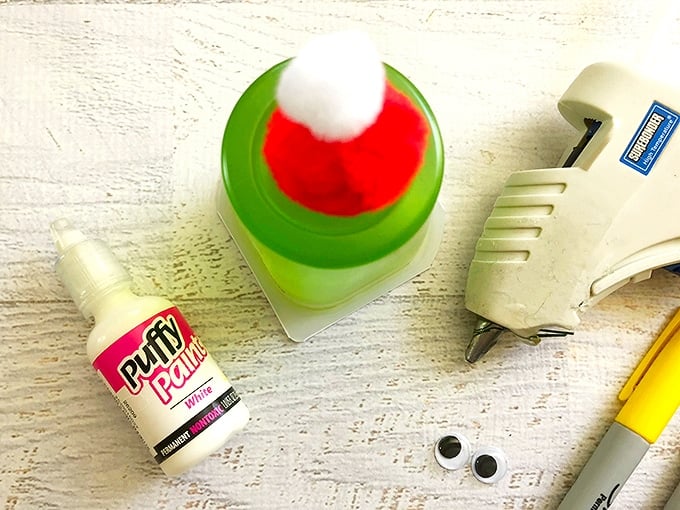 glue a red and white pom-pom on top of jello cup to make Grinch snack cups