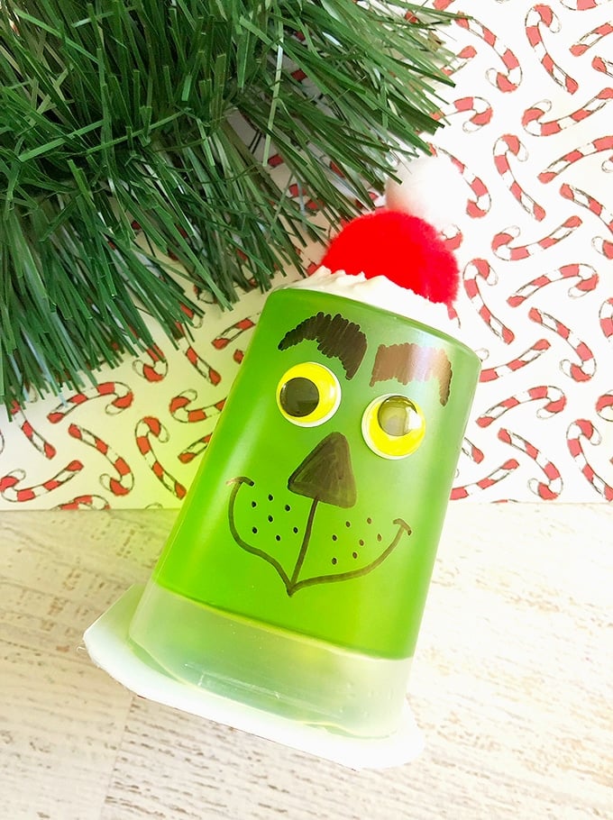 green jello cups decorated as Grinch are a fun kids snack