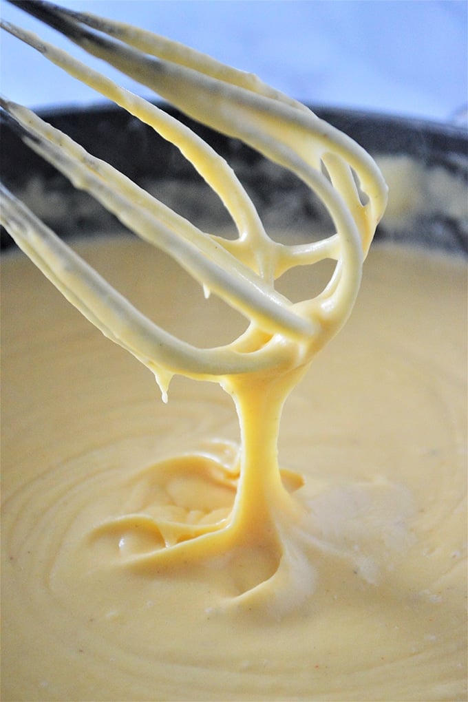 whisking cheese sauce