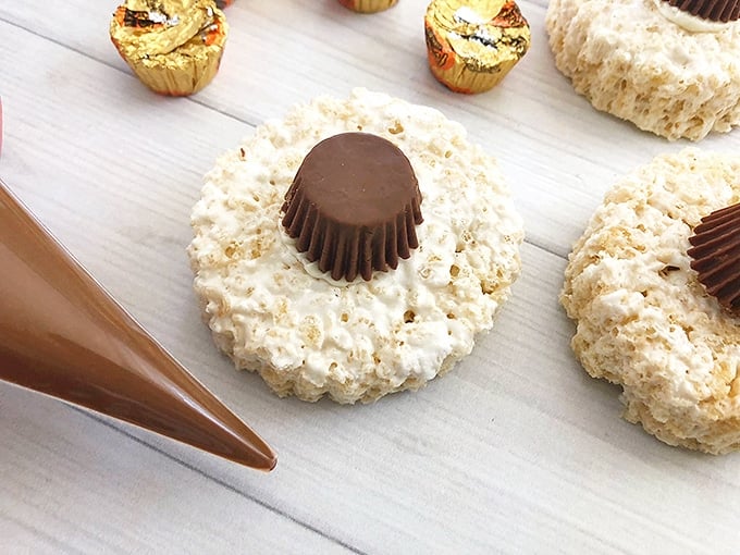 peanut butter cup placed on top of round rice krispies treats