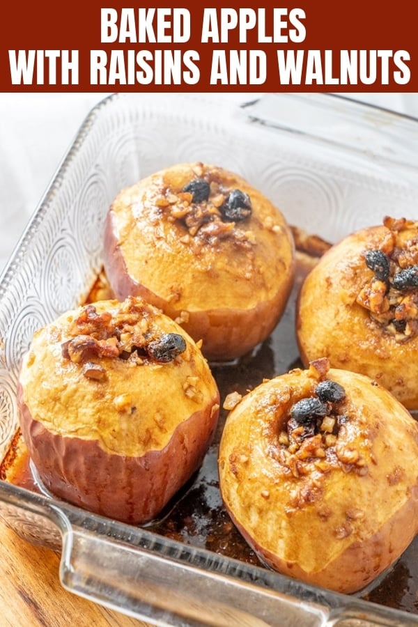 baked apples topped with raisins and walnuts in a baking dish