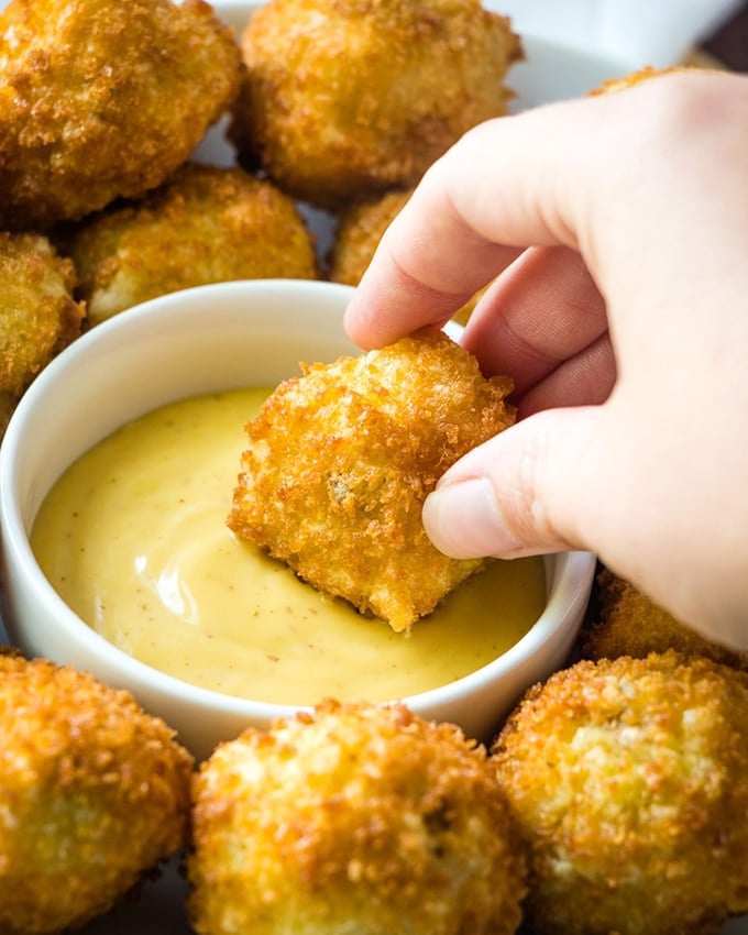 dipping potato croquettes in sauce